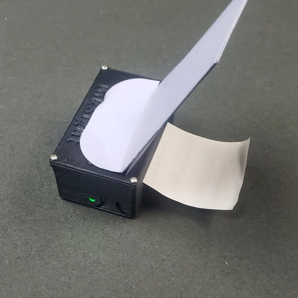 InkSight hidden printer with an envelope loaded and a printed spirit slip